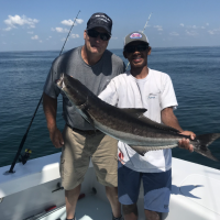 A captain and angler holding a fish in Islamorada.