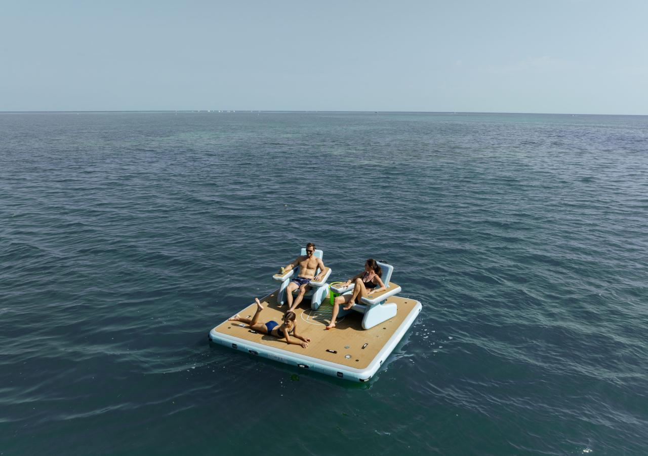 people relaxing on a floating dock