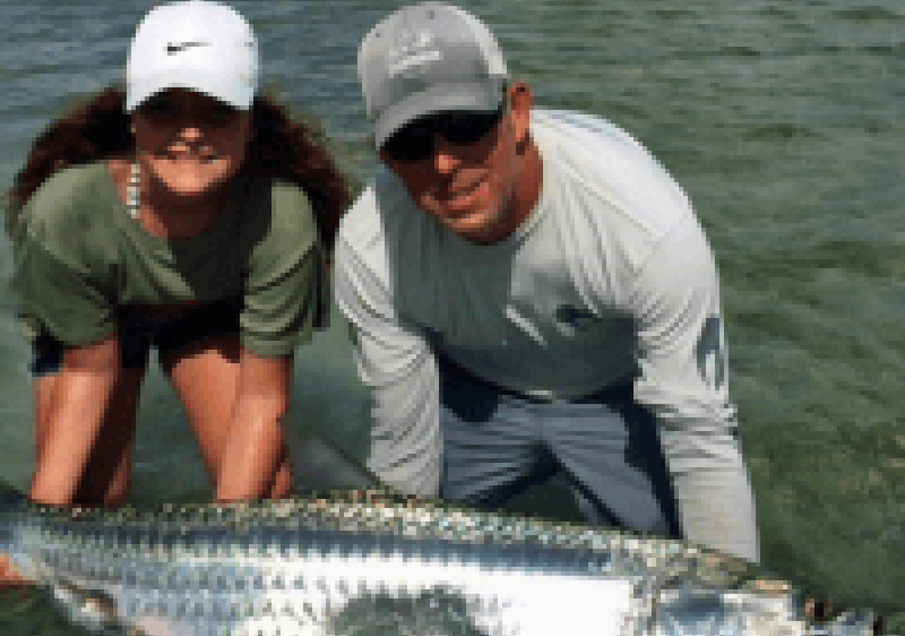 captain mark and a woman holding a fish