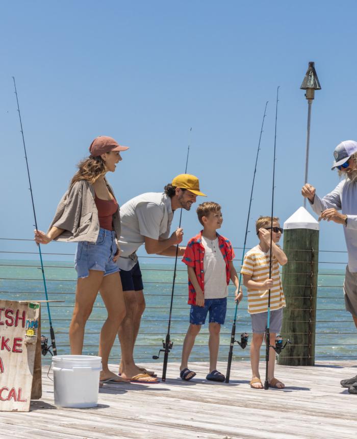 Family fishing off a dock