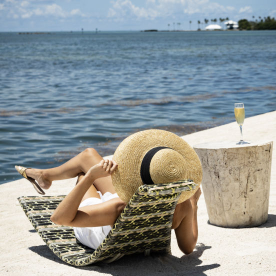 Woman On Beach Sipping Bubbly