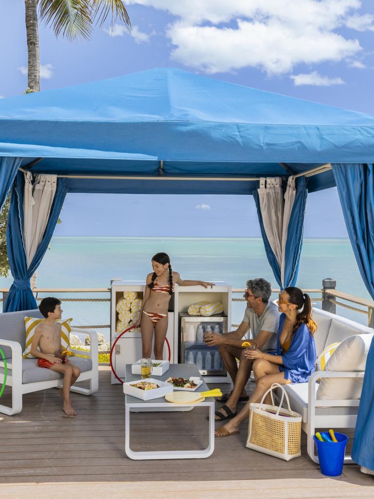 Family enjoying a cabana by the ocean