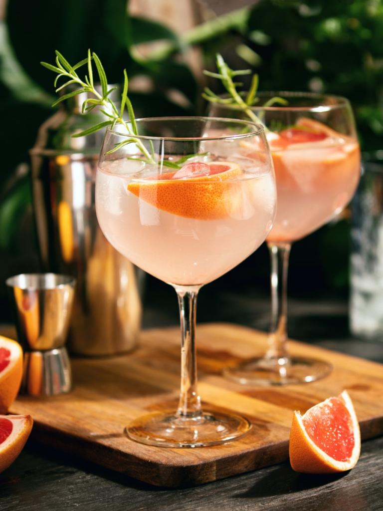 Grapefruit cocktails on a wooden serving board 