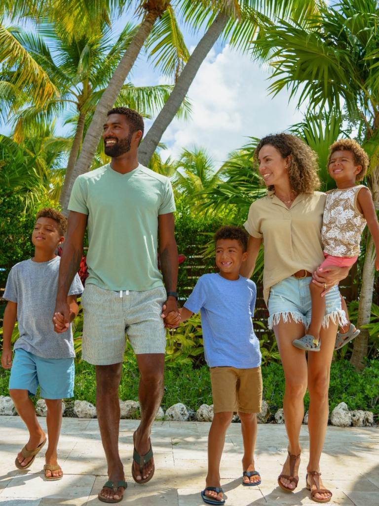 A family with three children walking hand-in-hand at La Siesta Resort & Villas