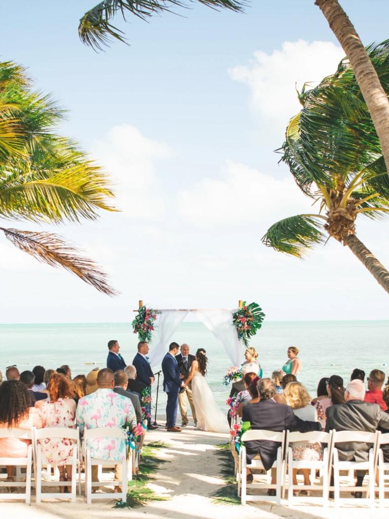 bride and groom under an alter at a beachfront wedding at Islamorada resort Collection