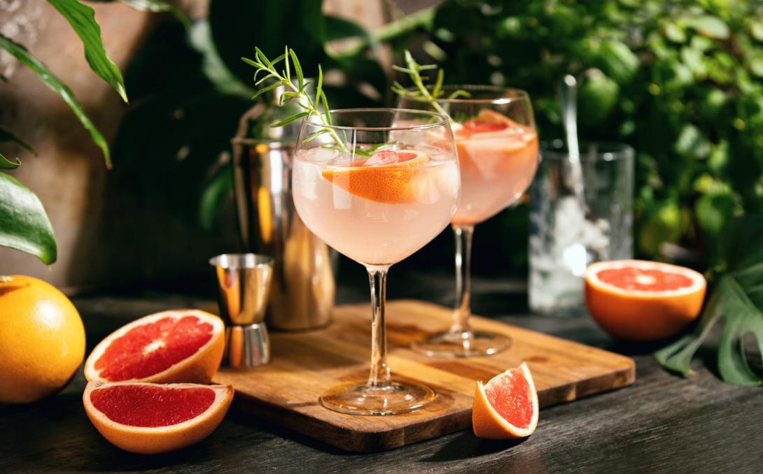 Grapefruit cocktails on a wooden serving board 