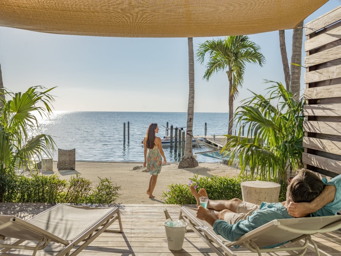 man and woman on holiday. lounging on a chair. 