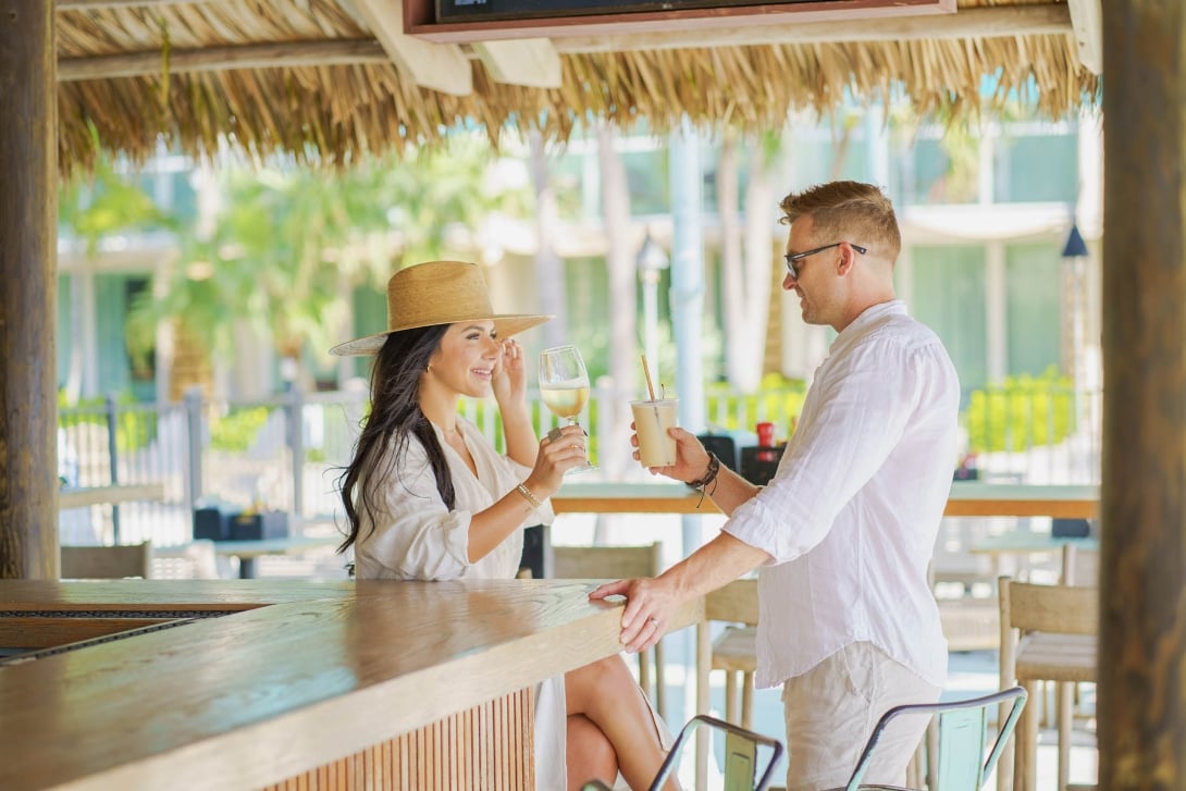 couple have a glass or wine at the outside bar